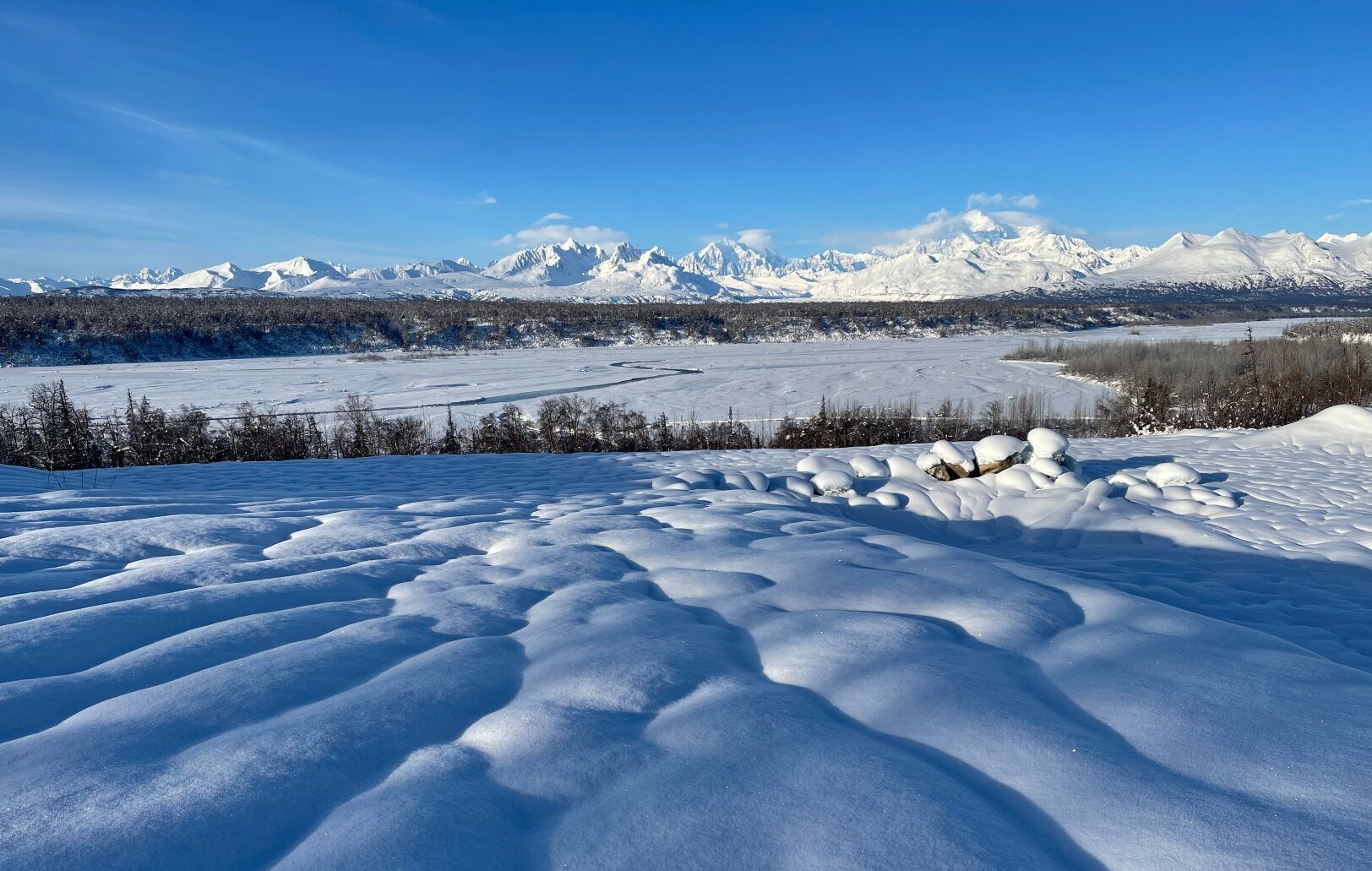 Snow drifts below the Alaska Range in winter